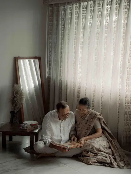 A wider view of their quiet afternoon, reminiscing together. The entire scene, with the soft curtains and warm light, felt like a painting of domestic bliss and enduring love.