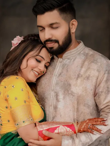 A sweet and romantic moment, with the bride resting her head on her partner's shoulder.