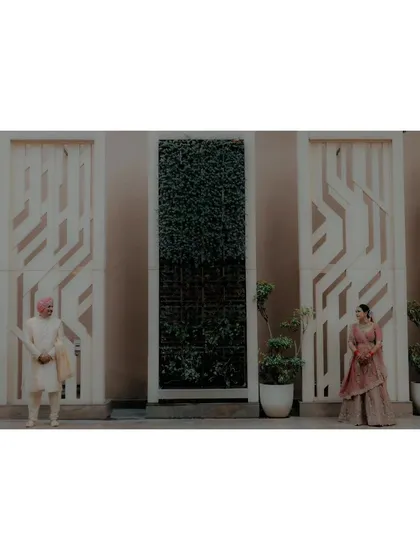 A minimalist wide shot of the couple, their distance from each other creating a modern and stylish composition.