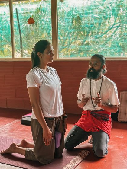 A student writes Sanskrit terms on the blackboard. Learning the language of yoga is a way of honoring its roots and understanding the deeper meaning behind the words we use in class.