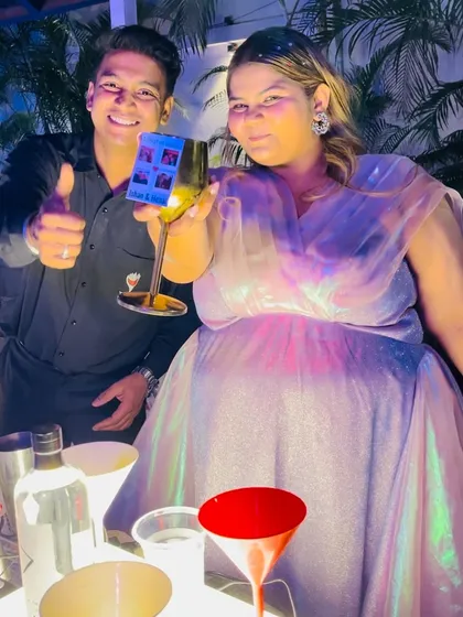 A happy moment with the bride, Henal, as she enjoys a custom-crafted drink at her cocktail party. I love interacting with guests and making sure everyone has a drink they love.