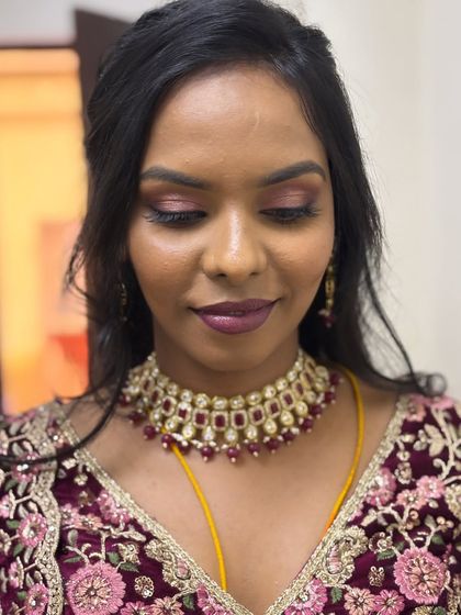 A close-up of Yamuna's pink glam eyes for her reception. The ombre deep plum lips add a touch of drama to this dreamy bridal look.