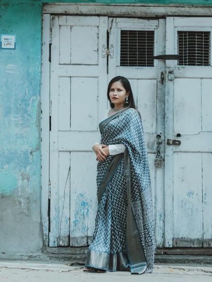 A stylish, posed shot against a rustic, textured background. This shows our versatility in creating both candid and more fashion-inspired pre-wedding portraits.