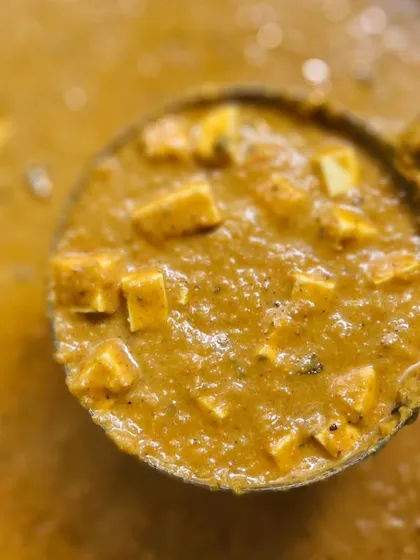 A ladle full of our rich and creamy paneer curry. We offer a variety of popular North Indian dishes to complement our South Indian specialties, ensuring there's something for every palate.