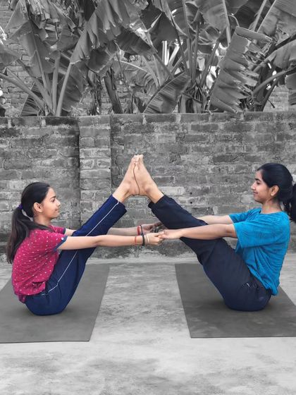 The Double Boat Pose (Navasana) with my student. This partner pose is not only a great core workout but also a fun way to build teamwork and synchronization.