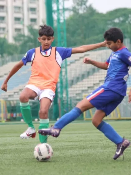 An intense 50/50 challenge during a match. We train our players to be decisive and competitive in every moment of the game.