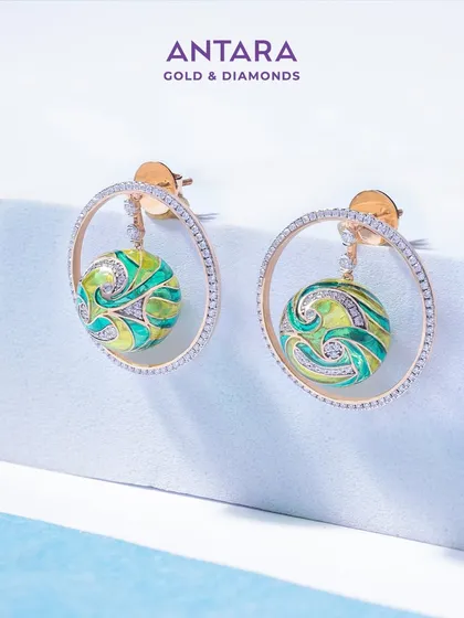 An unreplicable French enamel earring, where every angle reveals a new dimension of artistry. This piece is inspired by the concept of ‘art in motion,’ with a swirling enamel sphere inside a diamond hoop.