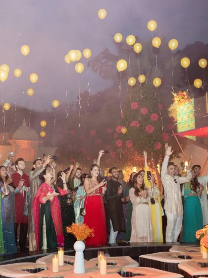 Guests releasing lighted balloons into the evening sky during a Mehendi function in Udaipur. A beautiful, symbolic moment that we can help orchestrate.