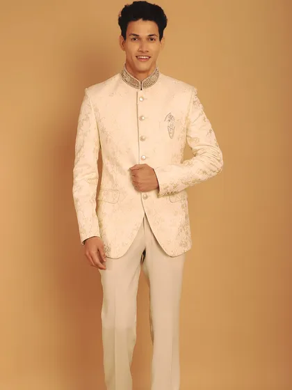 An ivory Jodhpuri suit is a statement of pure class. This piece features tone-on-tone thread work with dull gold zardozi, creating a look that is both understated and incredibly regal.