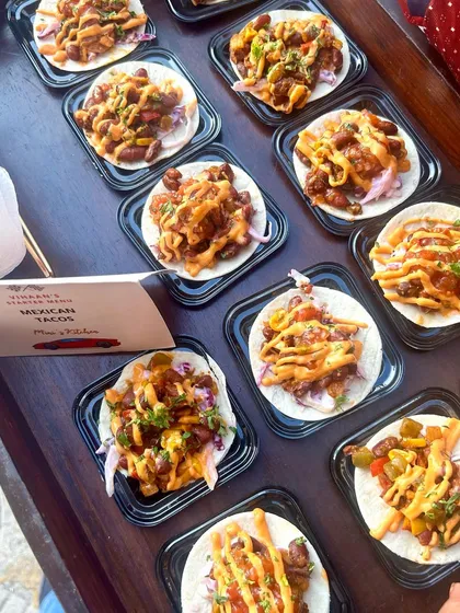 A platter of mini Mexican Tacos, loaded with beans, salsa, and sauces. These are perfect for adding a fun, international flair to your party menu.