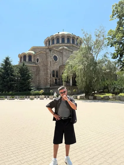 Posing in front of a cathedral in Sofia. This shows the full monochrome shorts outfit, a versatile and easy-to-wear look for any city exploration.