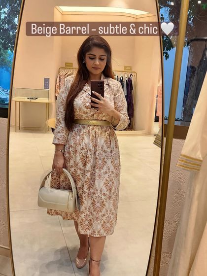 A beige barrel bag creates a subtle, chic, and seamless look with the printed co-ord set.