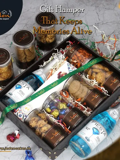 This is our vision of a perfect gift hamper, a treasure chest of memories waiting to be made. It features an assortment of our finest cookies and chocolates in jars, paired with non-alcoholic sparkling drinks, all nestled in an elegant keepsake box.