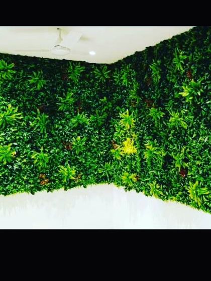 A full-corner green wall installation for an indoor room. Covering two adjacent walls creates an immersive, jungle-like feel, making the room feel like a retreat.