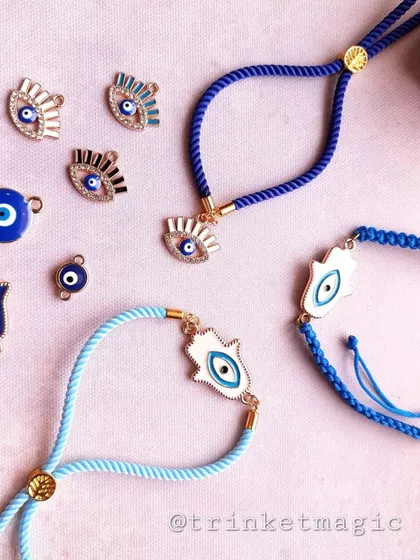 Good vibes only. My evil eye Rakhi collection is all about style and protection. This flat lay shows some of the Hamsa hand and evil eye charms you can choose from, all on adjustable bands that can be worn as bracelets all year.