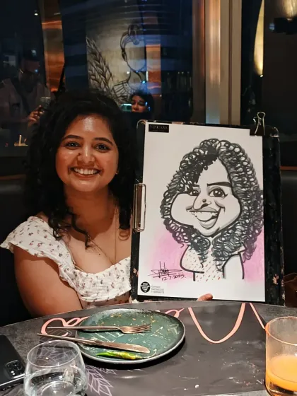 A guest with beautiful curly hair, perfectly captured in her caricature at Nincasa Pune.