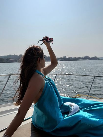 A candid moment, holding up my sunglasses against the sun.