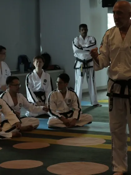 Listening intently as a Grand Master explains a principle of Taekwon-Do. To be a good teacher, I must always remain a student.