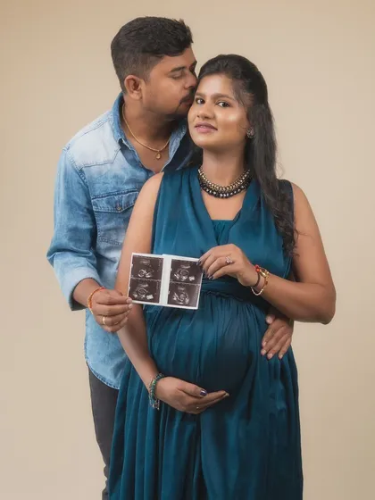 Holding the first glimpse of their baby, their future is literally in their hands. This portrait is a classic announcement, filled with the tenderness of his kiss and the pride in her smile.