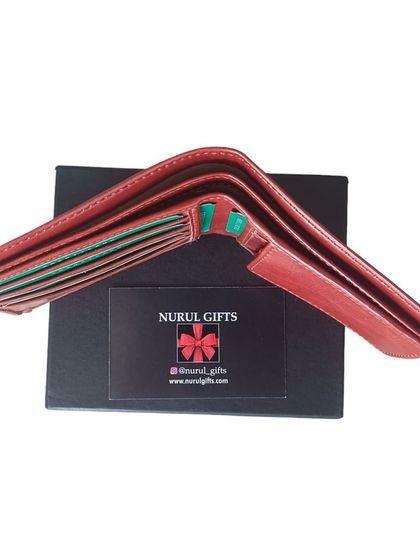 An open view of the red leather wallet, showing its multiple compartments and quality interior lining.