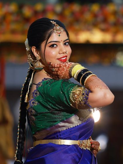 A playful pose from the bride, showing off her intricate henna and beautiful makeup.