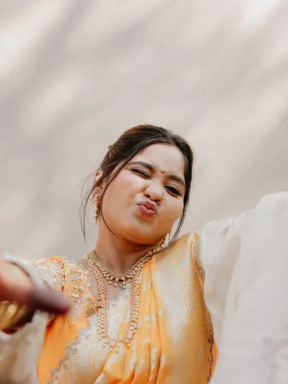A fun, candid moment that captures the bride's personality. Even with traditional attire, it's important to feel like yourself.