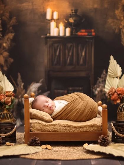 A full view of a rustic newborn photoshoot, highlighting the careful arrangement of props and textures to achieve a warm, earthy, and timeless look.