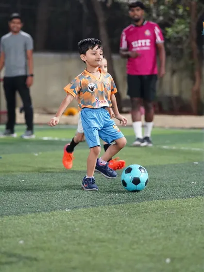 A young player dribbles with confidence, a skill developed through our consistent and dedicated coaching.