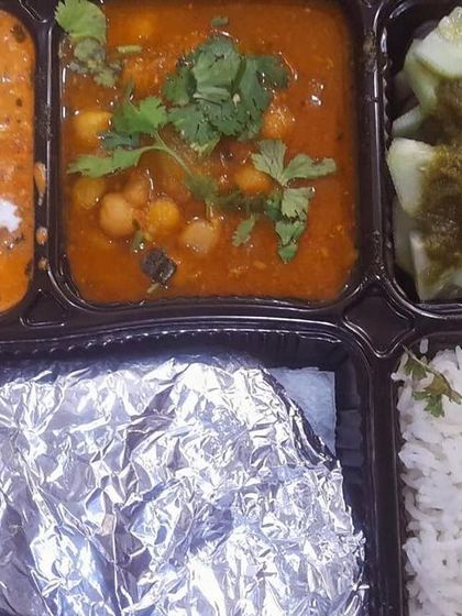 A delicious thali with shahi paneer and chole. The creamy, nutty paneer gravy and the spicy chickpea curry offer a wonderful contrast of flavors.