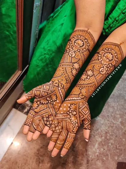 This design features a stunning mandala on the back of the hand, with lotus and peacock motifs flowing down the arm.
