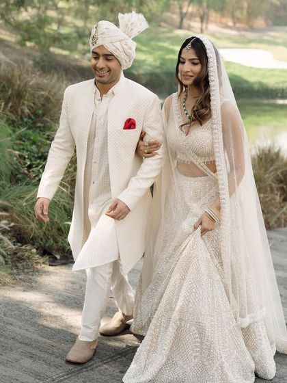 A classic wedding portrait, with the groom lovingly guiding his bride. The beautiful natural light and the lush surroundings of the golf club create a romantic and timeless image.