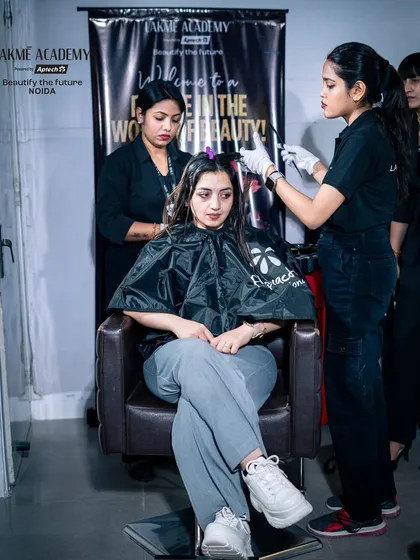 A student applying a hair treatment to a live model under the supervision of our expert trainers.