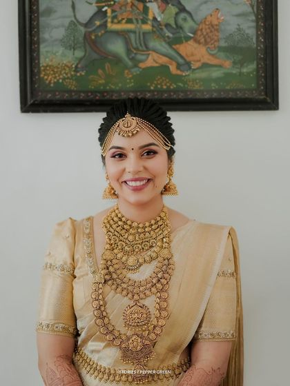 A stunning portrait of the bride, her intricate gold jewelry and elegant hairstyle perfectly captured.