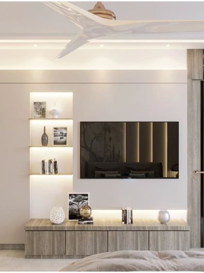 This bedroom showcases a clean and contemporary TV unit with integrated storage. The light wood finish and minimalist design are complemented by the natural light from the large window.