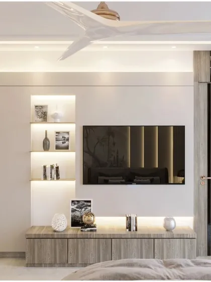 This bedroom showcases a clean and contemporary TV unit with integrated storage. The light wood finish and minimalist design are complemented by the natural light from the large window.