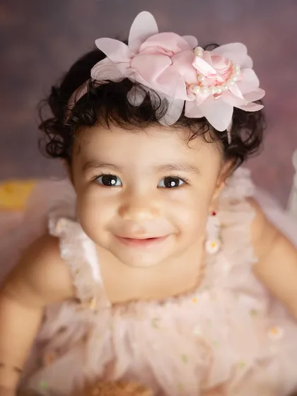 A beautiful close up portrait of the birthday girl. Her bright eyes and gentle smile are the stars of this shot.