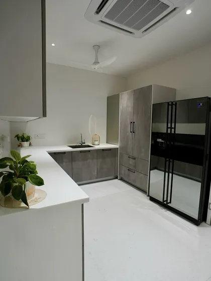 The wet kitchen in the Reddys' Hyderabad home, featuring durable, easy-to-clean cabinets in a concrete-look finish, perfect for heavy daily use.