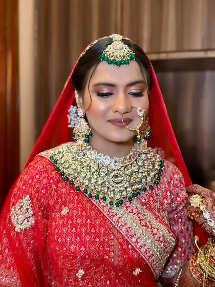 A closer look at the flawless base and soft eye makeup that lets the heavy jewellery and bold outfit shine.