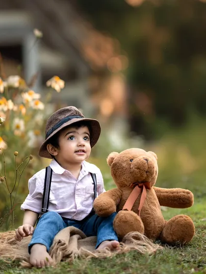 A sweet moment with a furry friend. Using props like this teddy bear can help little ones feel comfortable and create adorable, story-like images.