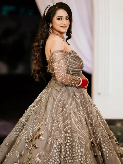 My client looking absolutely radiant for her reception. Her off-shoulder embellished gown is paired with soft curls and a sparkling hair accessory.