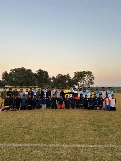 A beautiful day for football. Both our team and the team from Zinc Football Club pose together after a great game.