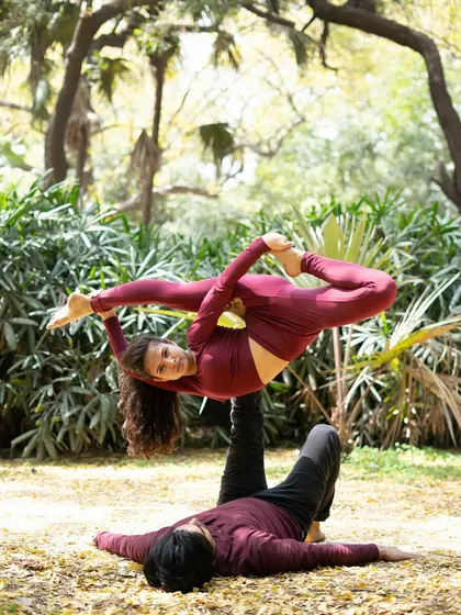 A graceful acroyoga pose that highlights the flyer's flexibility and the serene connection between the partners.