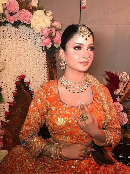 This portrait highlights the beautiful jewelry and the soft, radiant glow of the makeup.