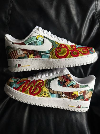 A pair shot of the cinema custom sneakers, with personalized initials "NB".