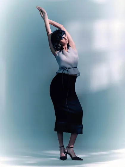 A full-length shot from the same series, capturing a graceful, dance-like pose. The motion blur on the background enhances the feeling of movement and artistry.