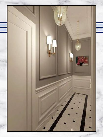 This hallway showcases our commitment to classical design. The space features detailed wall and baseboard mouldings, elegant wall sconces, and a striking black and white marble floor.