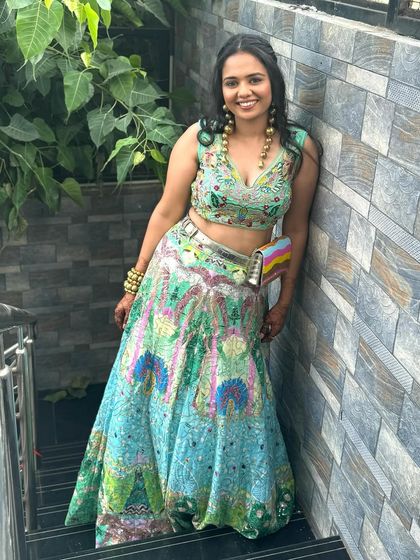 A fusion flair for the modern woman. This look is for someone who loves to break boundaries, pairing a unique, colorful lehenga with a fresh and subtle makeup look and soft, open curls.