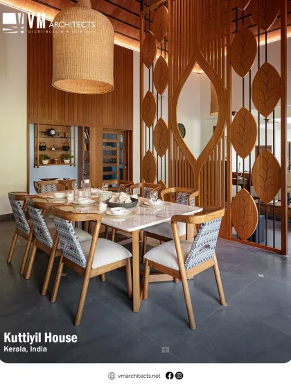 Craftsmanship is central to my work, as seen in this dining area at Kuttiyil House. The custom-designed wooden partition with its leaf motif and the large woven pendant light create a space that is both artistic and functional.