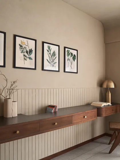This custom-designed floating study table is a perfect example of creating functional beauty. The combination of dark wood, fluted wall panelling, and brass details turns a simple corner into a sophisticated workspace.