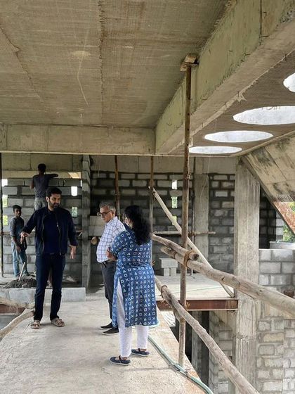 A site visit with clients during the construction phase. We walk through the raw space, discussing the framing of the skylights and how the structure is taking shape according to the plan.